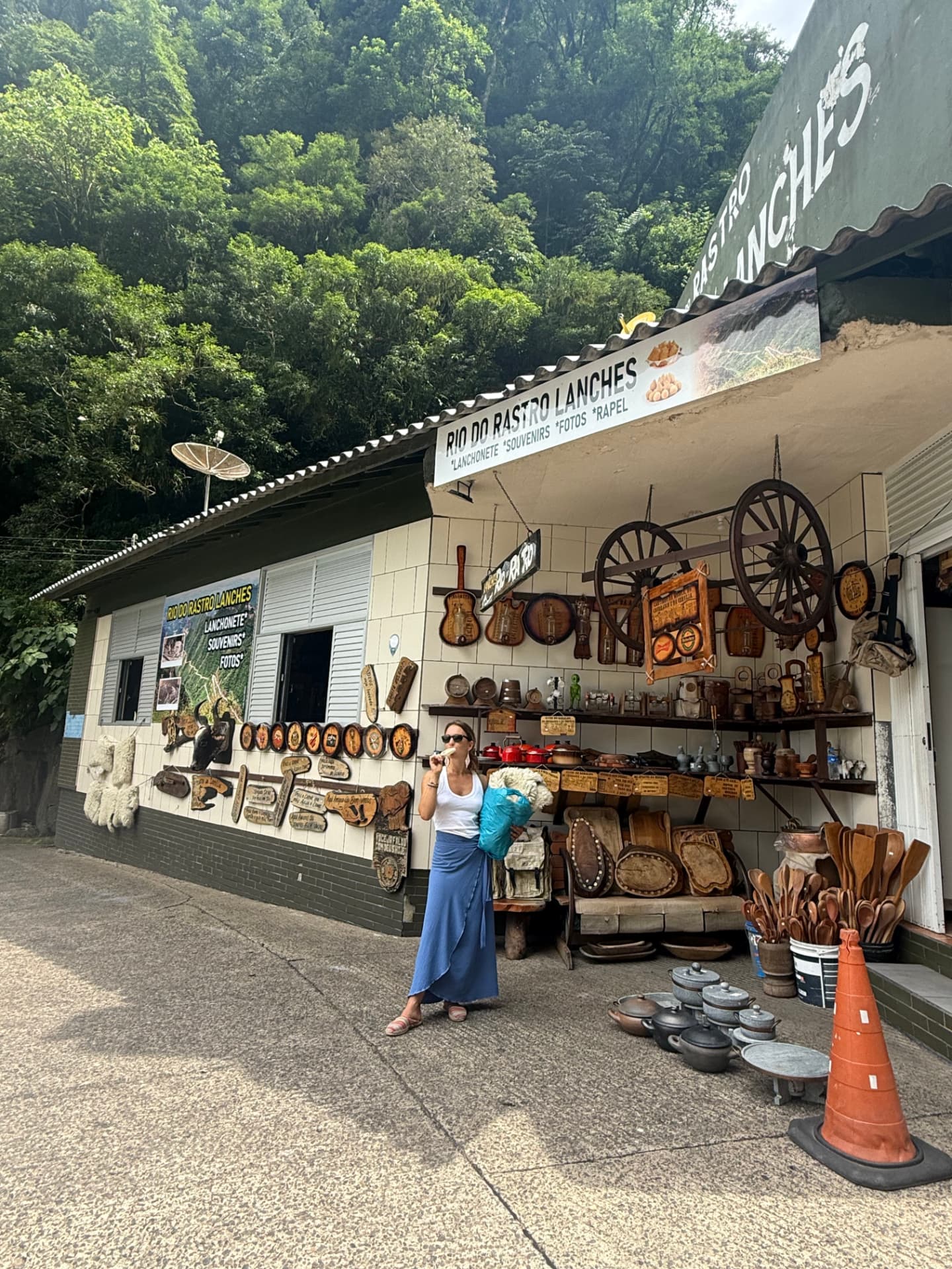Mikaela browsing handcrafted goods at a roadside stall in the mountains of Brazil